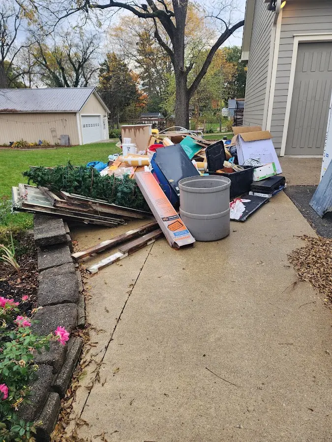 Dumpster being loaded with debris for Estate Cleanout Dumpster Rental in Bastrop